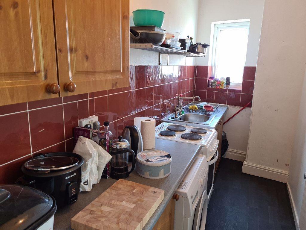A well-used kitchen area featuring a basic coun...