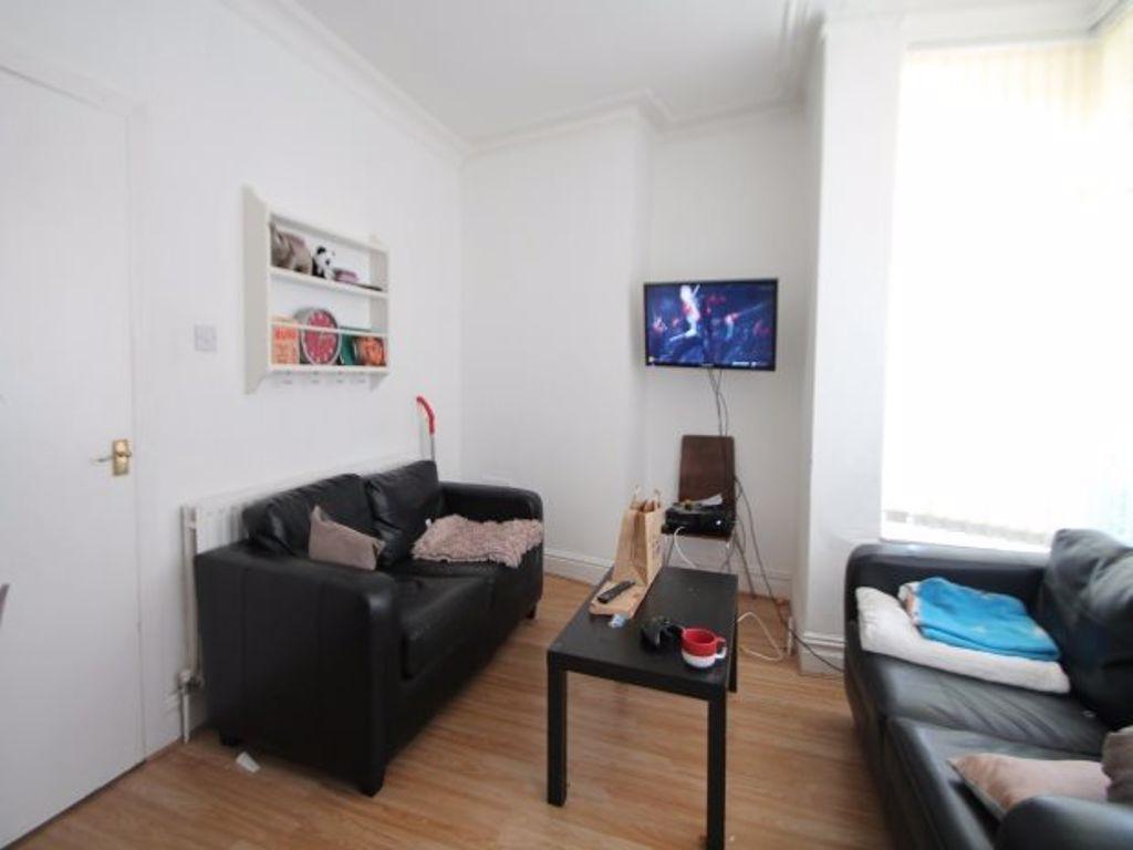 A bright and inviting living room featuring com...