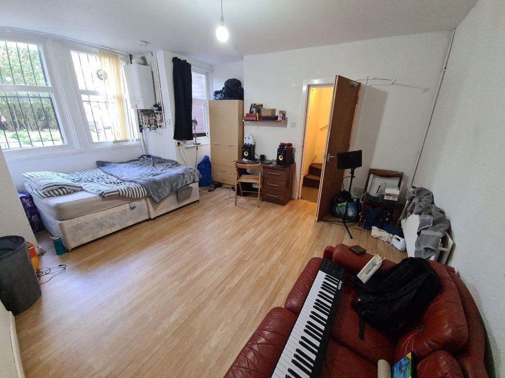 A spacious and well-lit living room featuring a...