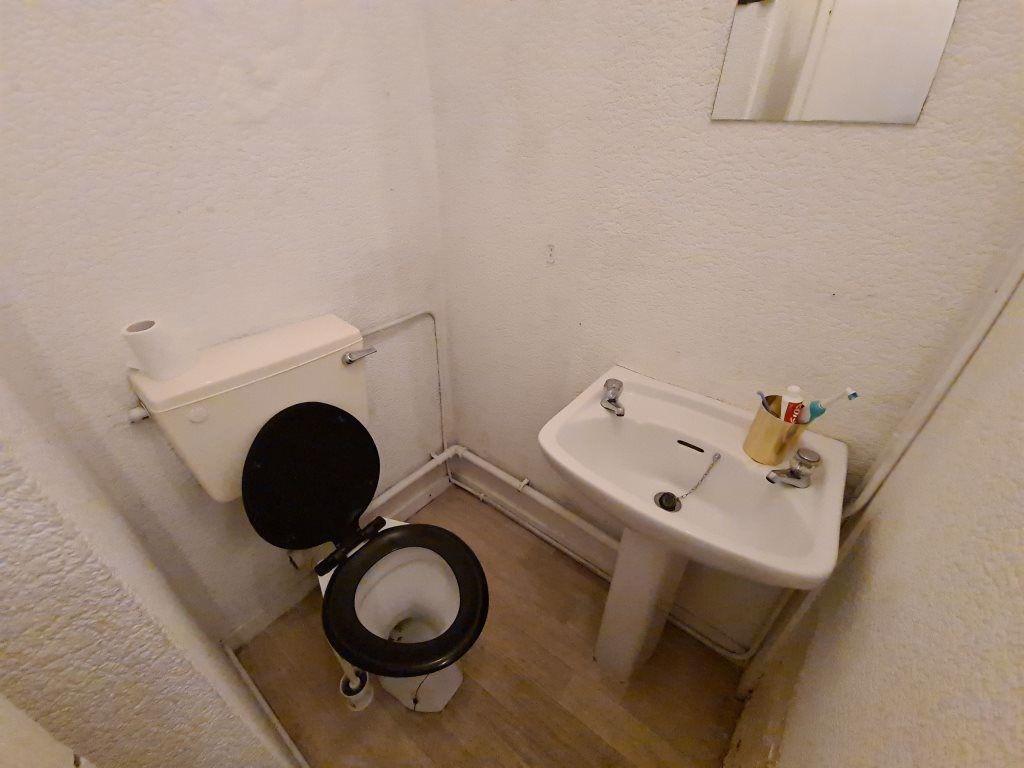 A clean bathroom with basic fixtures including ...