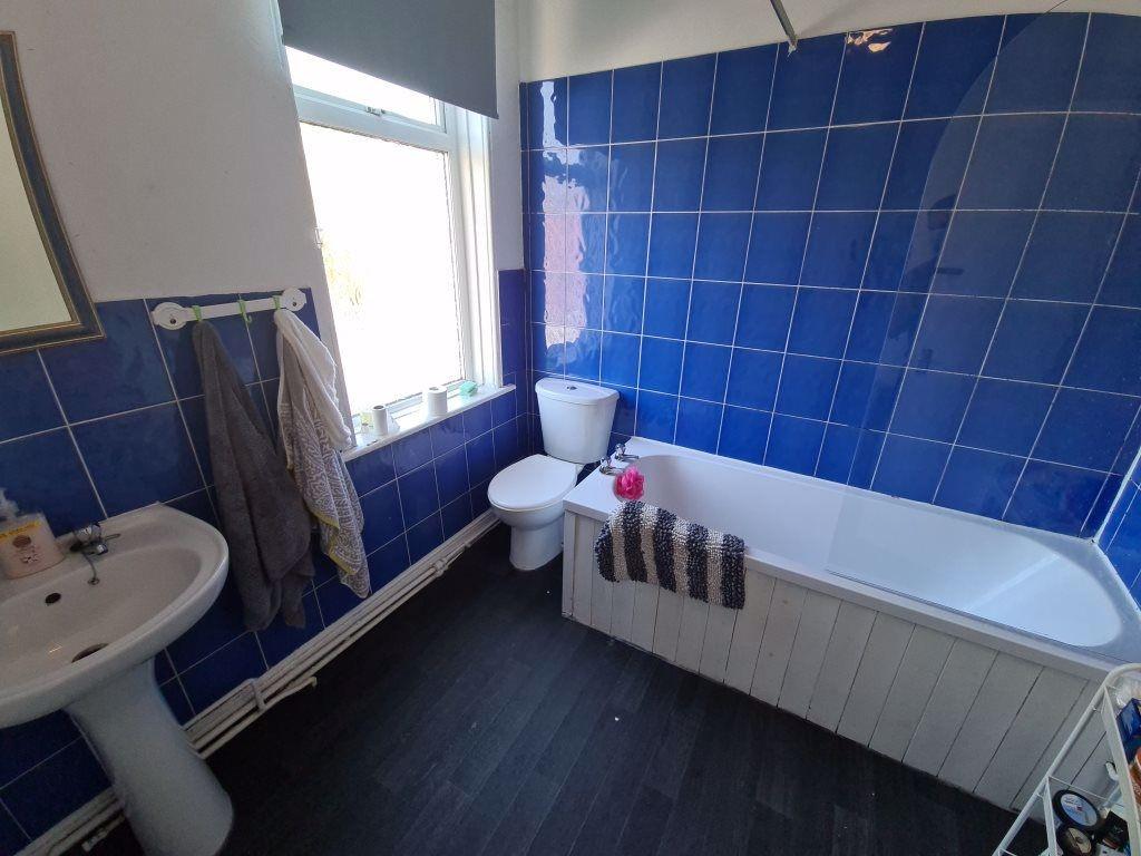 A clean and modern bathroom featuring a large b...