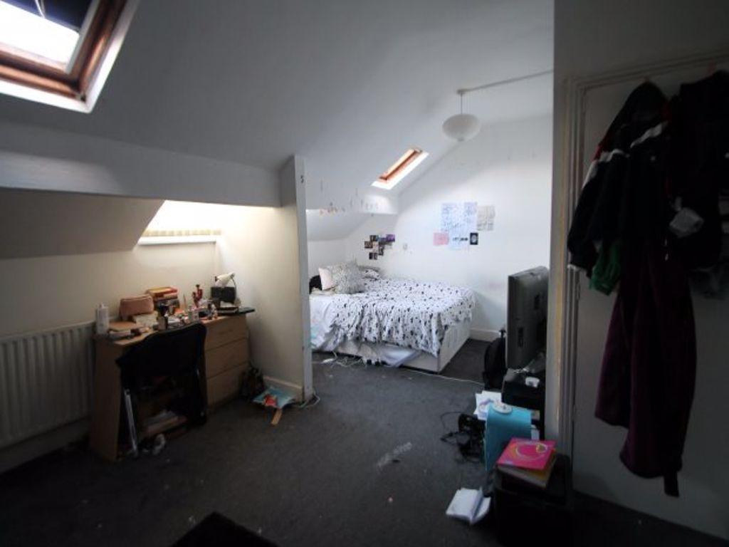 A cozy bedroom with natural light coming from s...