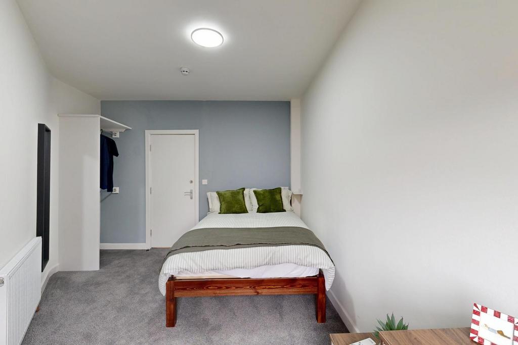 A bright and spacious master bedroom featuring ...