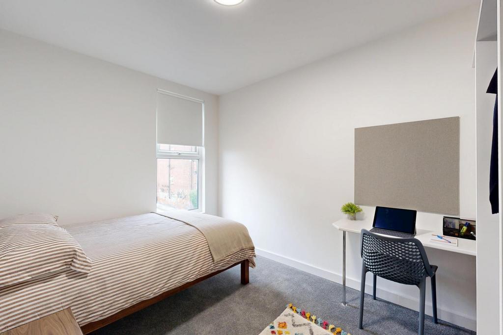 Bright and airy master bedroom featuring a comf...