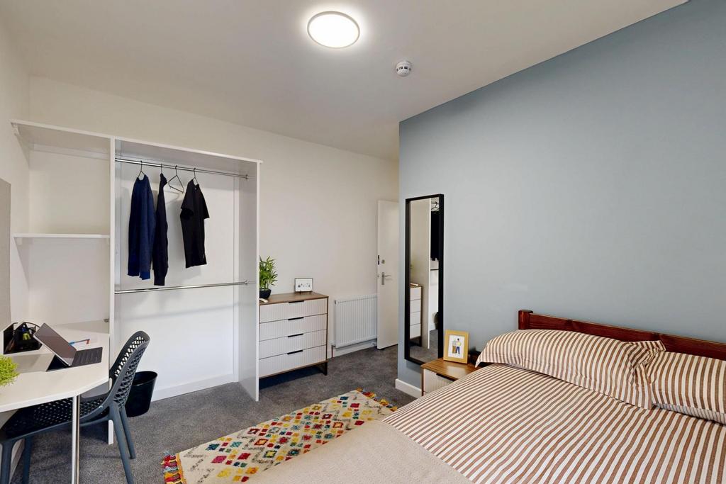 A clean and inviting bedroom with a comfortable...