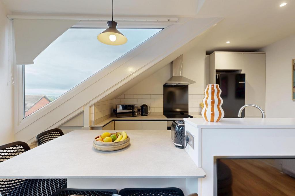 Bright and modern living room with ample natura...