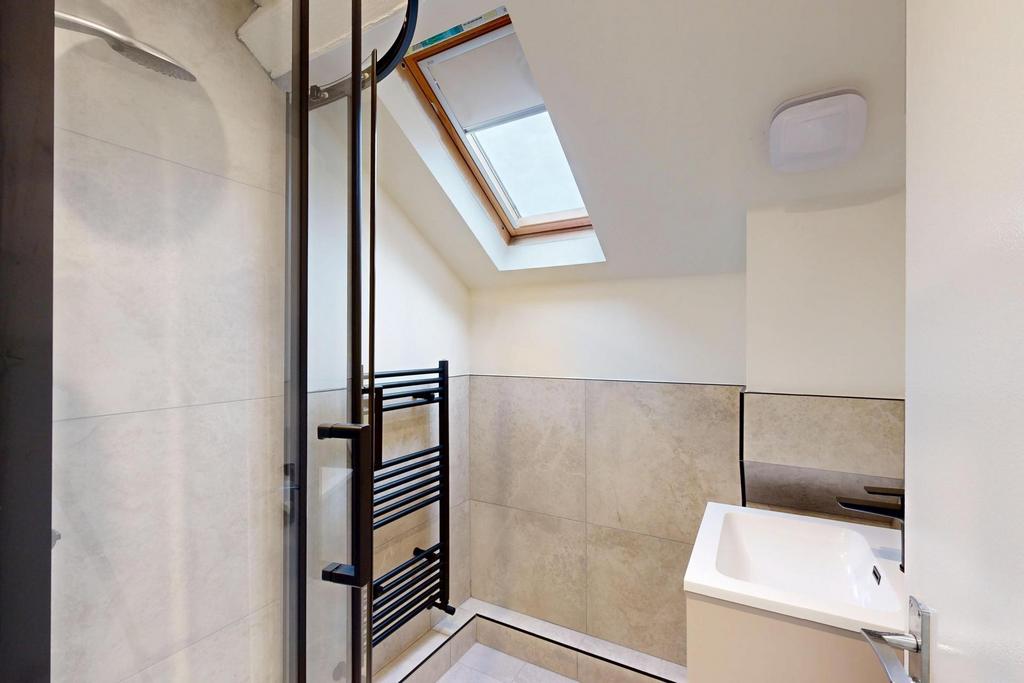 Bright and modern bathroom with a skylight wind...
