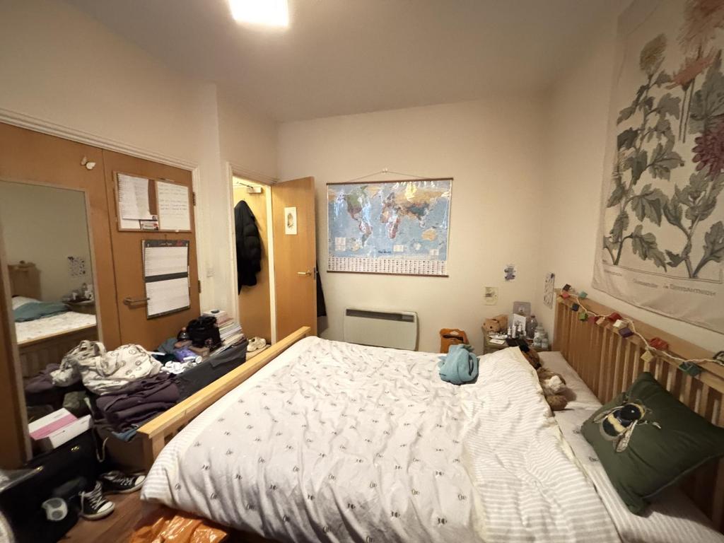 A cozy bedroom featuring a double bed with deco...