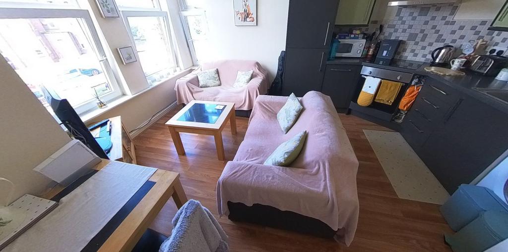A bright and welcoming living room featuring a ...