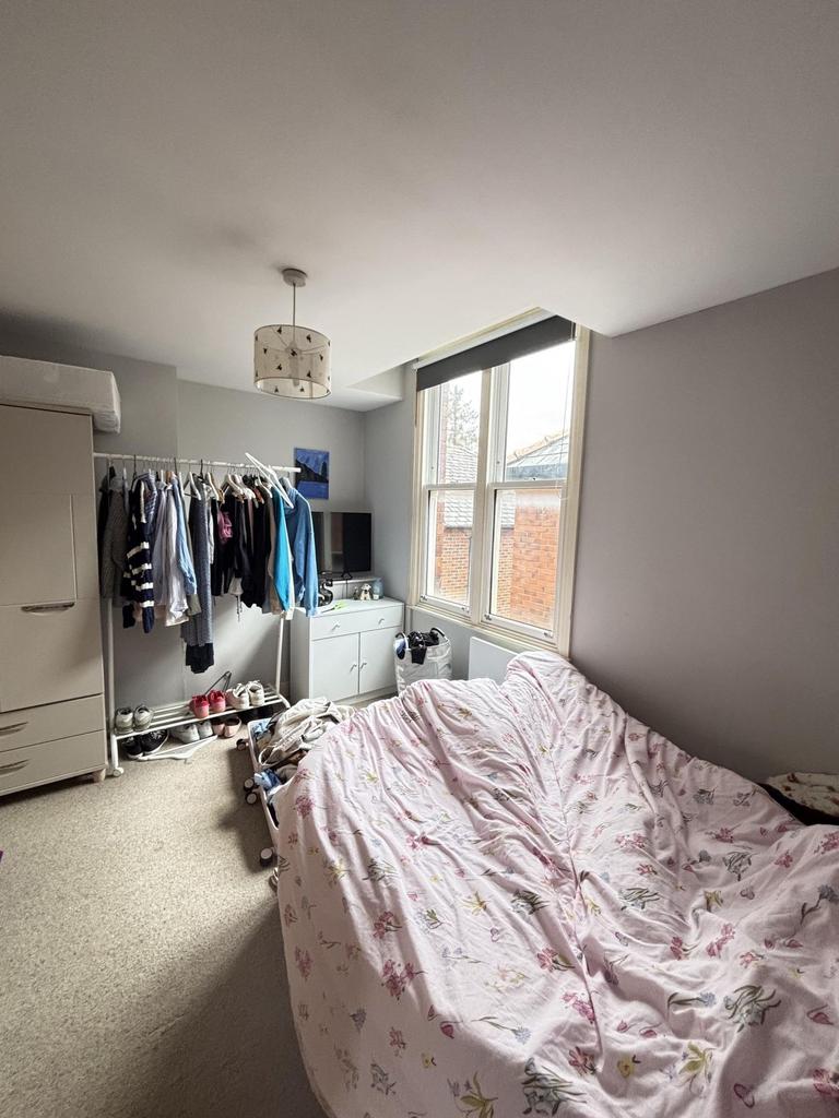 A cozy bedroom featuring a double bed and a win...