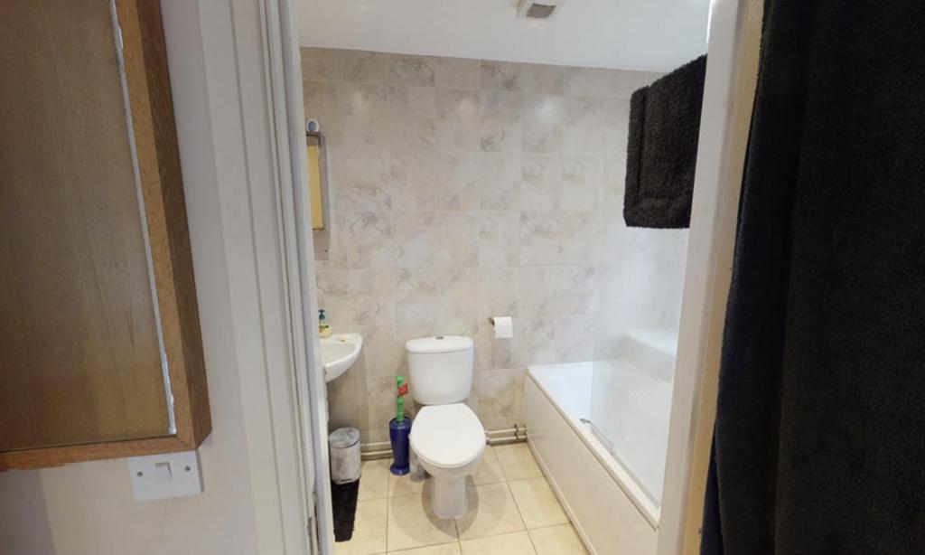 A clean and functional bathroom with a toilet, ...