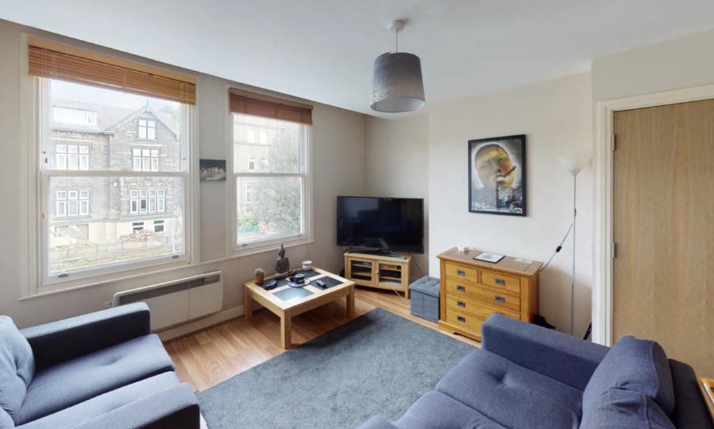 A well-lit, spacious living room featuring comf...