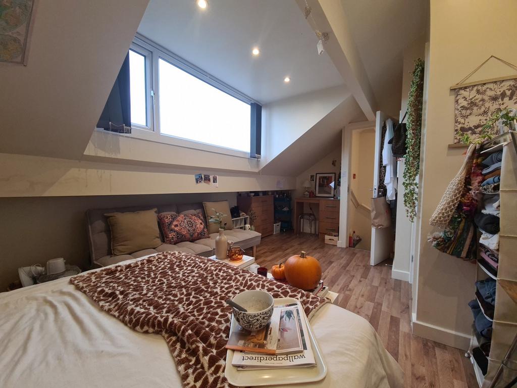 A spacious, well-lit contemporary living room w...