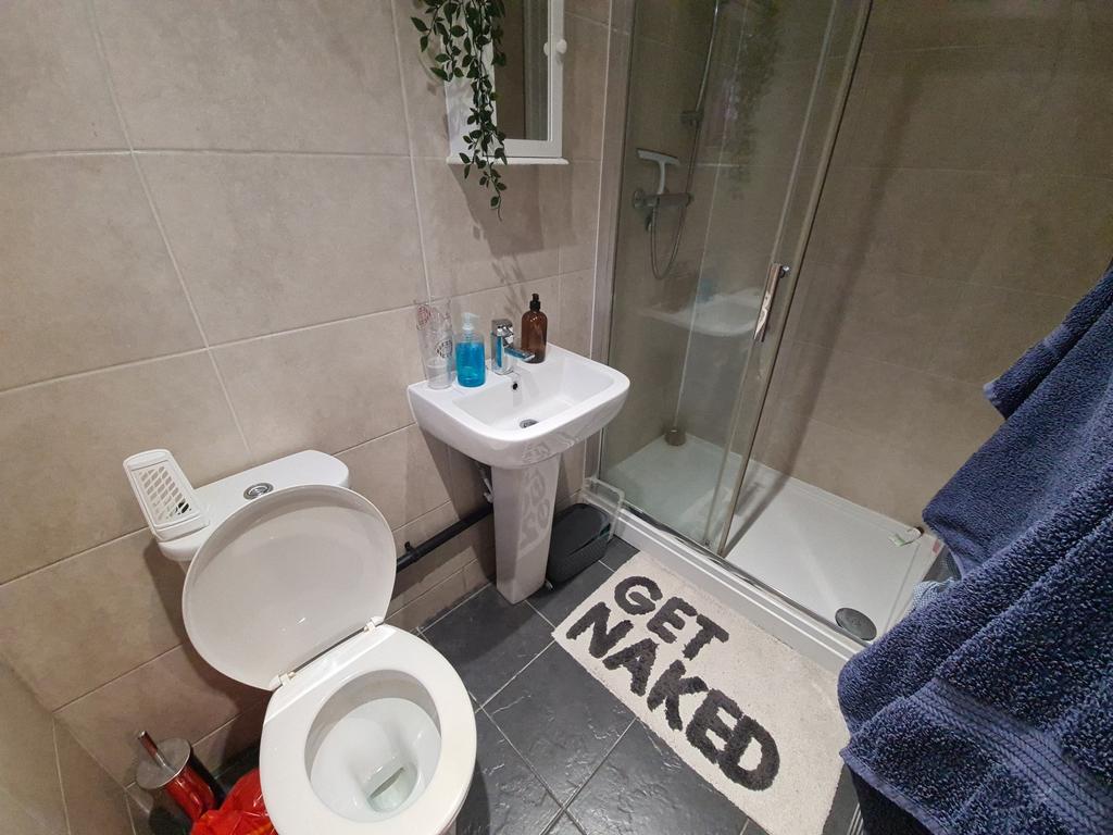 A clean and modern bathroom featuring a toilet,...