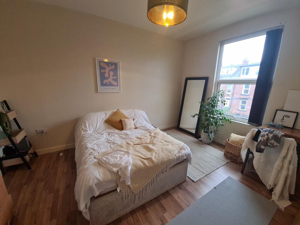 Bright and inviting master bedroom with ample n...