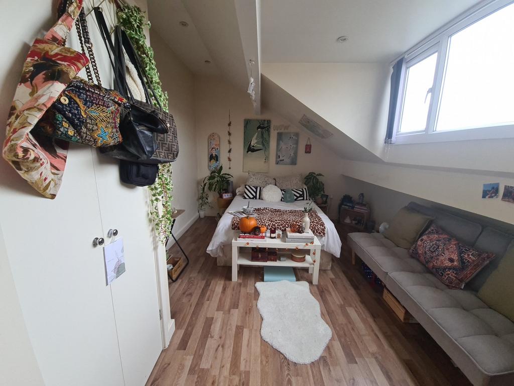 A cozy and well-maintained living room with nat...