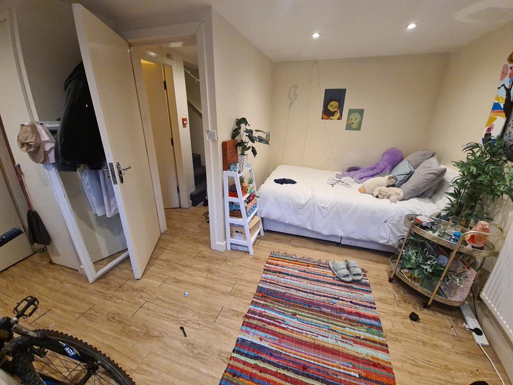 A bright and cozy bedroom featuring a large bed...