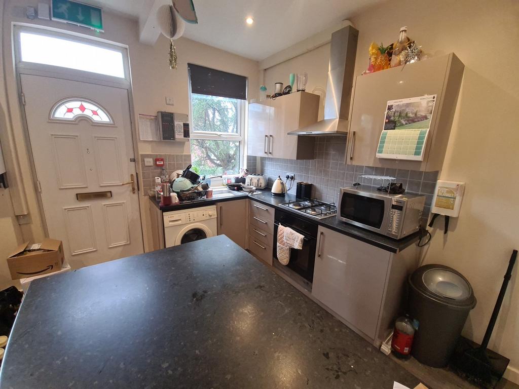 A modern and well-lit kitchen with appliances a...