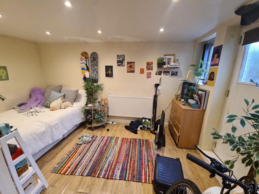 A well-lit, cozy living room with comfortable s...