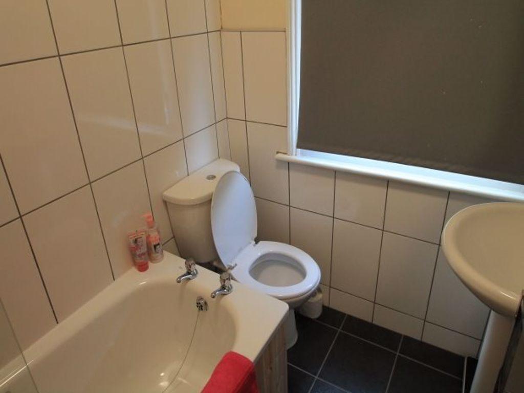 A functional bathroom featuring a standard toil...