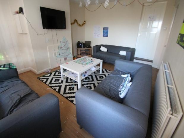 A spacious and well-maintained living room feat...