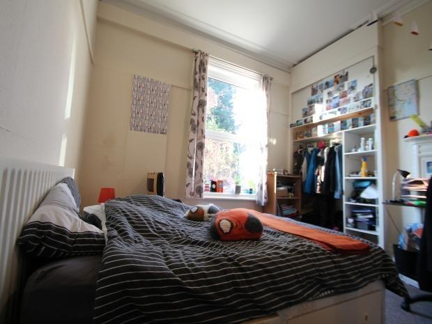A cozy bedroom featuring a double bed with a st...