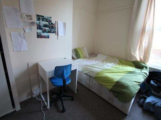 A spacious double bedroom featuring a double be...