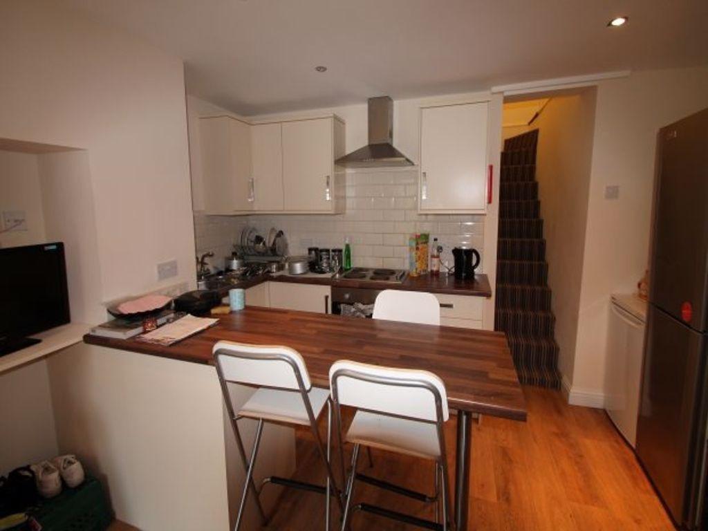 Modern kitchen area featuring a wooden dining t...