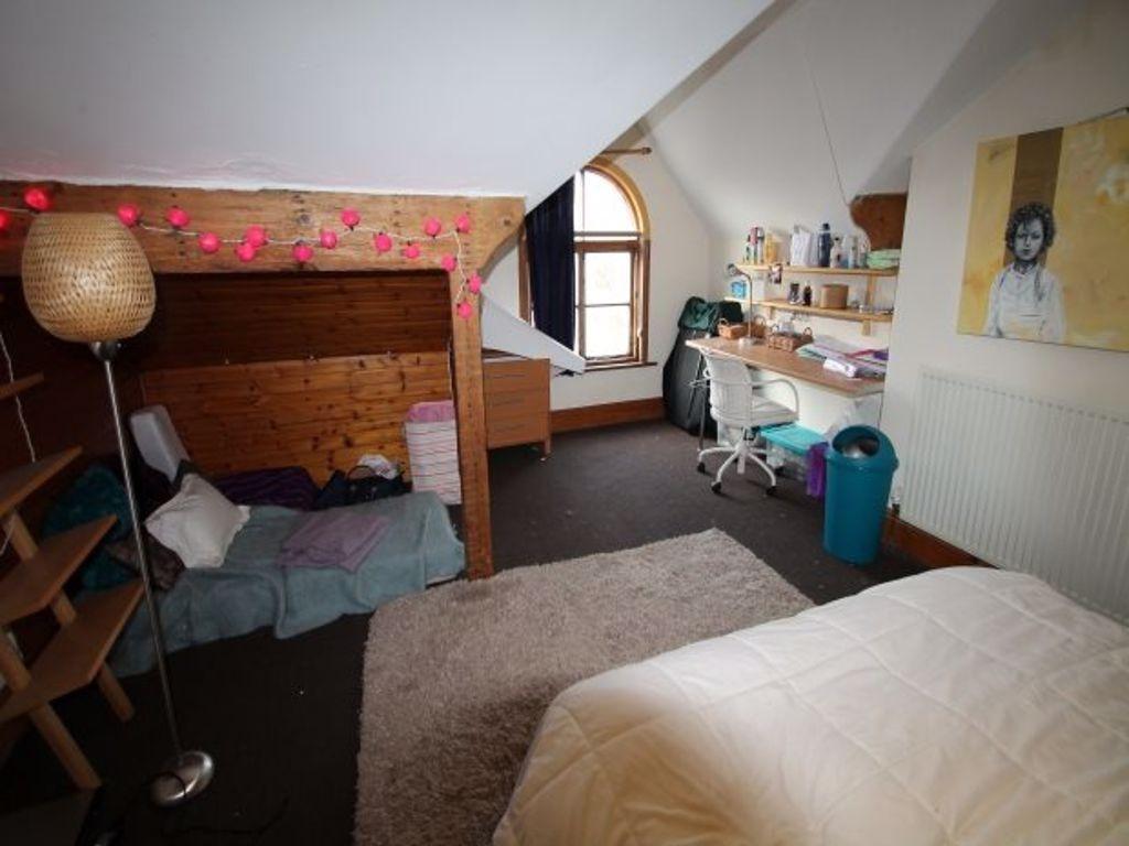 A cozy bedroom with a single bed, a wooden bunk...