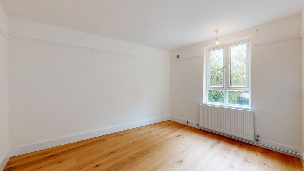 A bright, spacious living room with large windo...