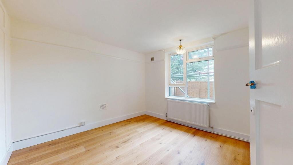Bright and spacious living area with large wind...