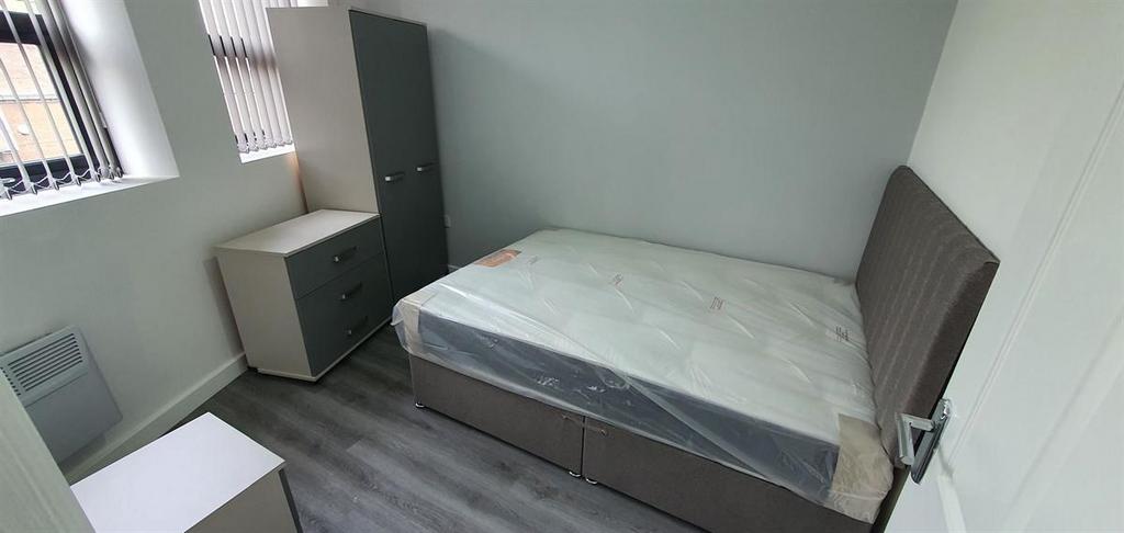 A clean, compact bathroom featuring essential f...