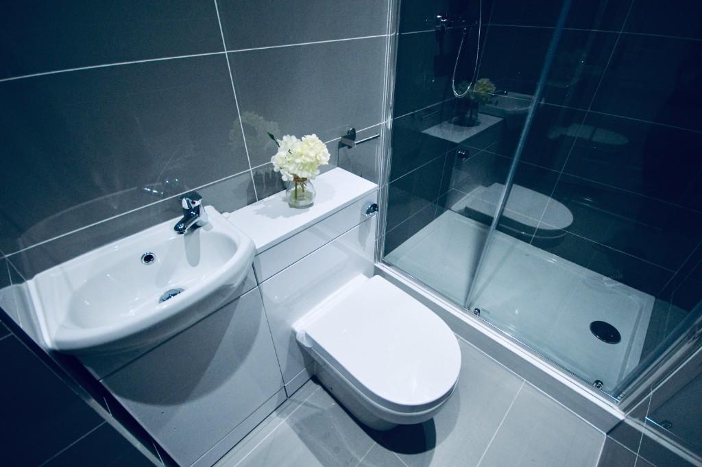 Modern and clean bathroom with a white toilet a...