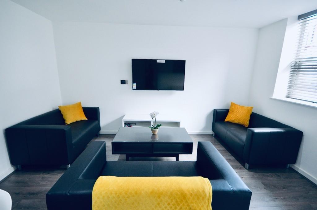 A modern, well-lit living room featuring comfor...