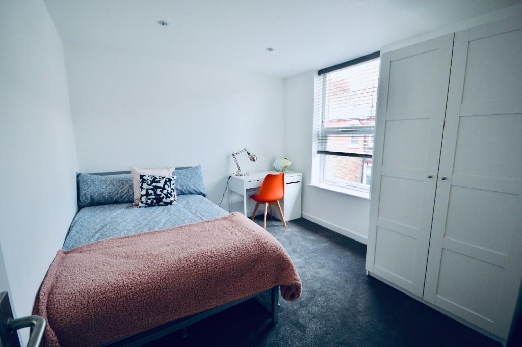 A bright and inviting double bedroom featuring ...