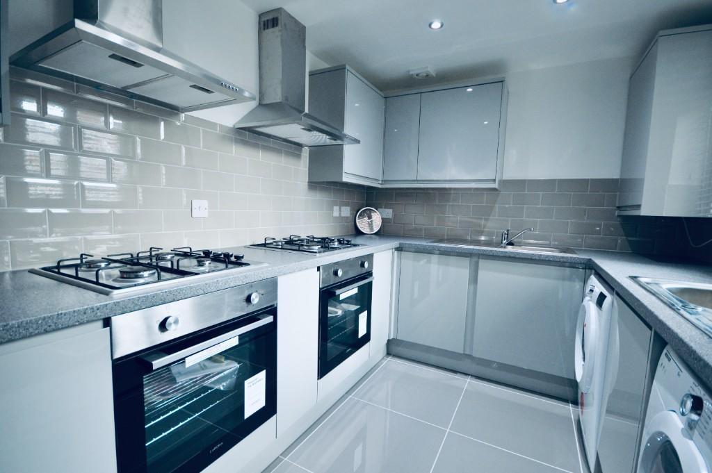 Modern, well-maintained kitchen with sleek cabi...