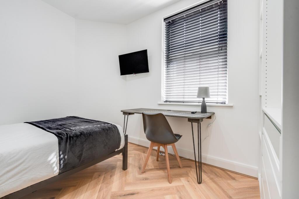 A clean and well-lit small bathroom featuring m...