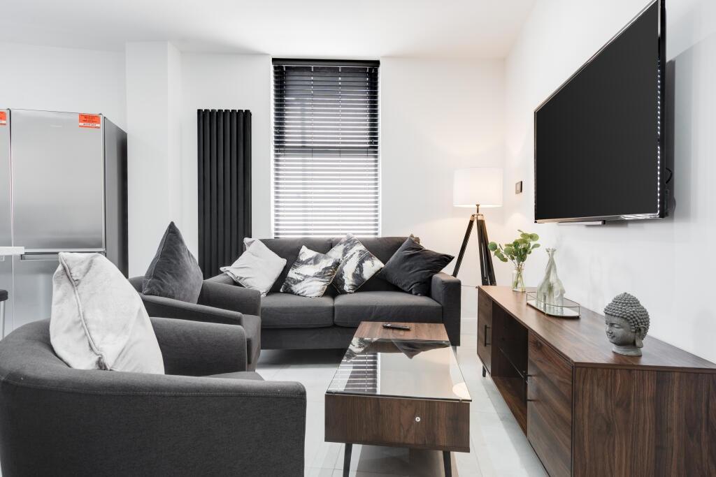 A bright and stylish living room featuring a co...