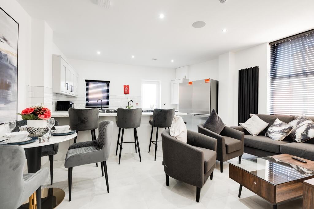 A spacious and modern living room filled with n...