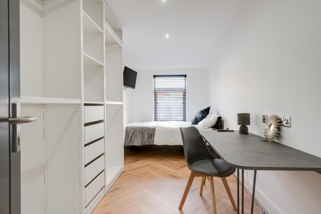 A bright and modern bedroom featuring a double ...