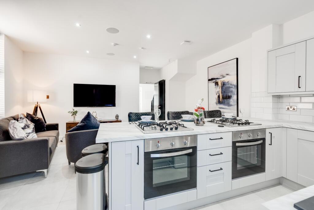 A modern, bright kitchen with ample natural lig...