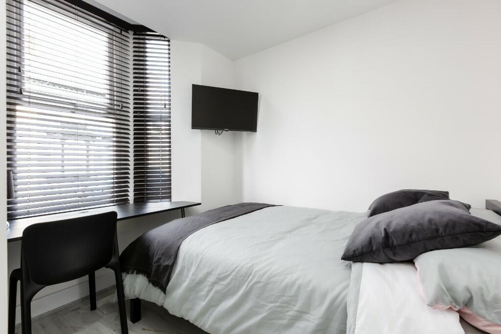 A bright and spacious master bedroom featuring ...