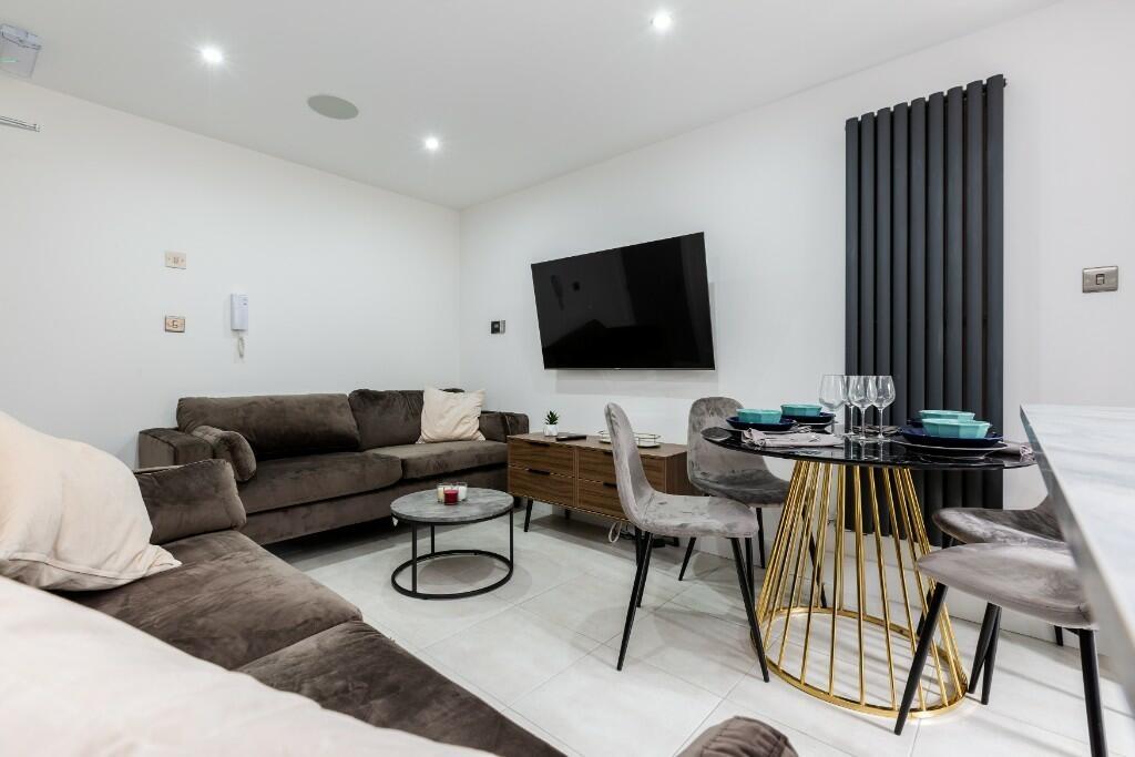 A modern and spacious living room featuring com...