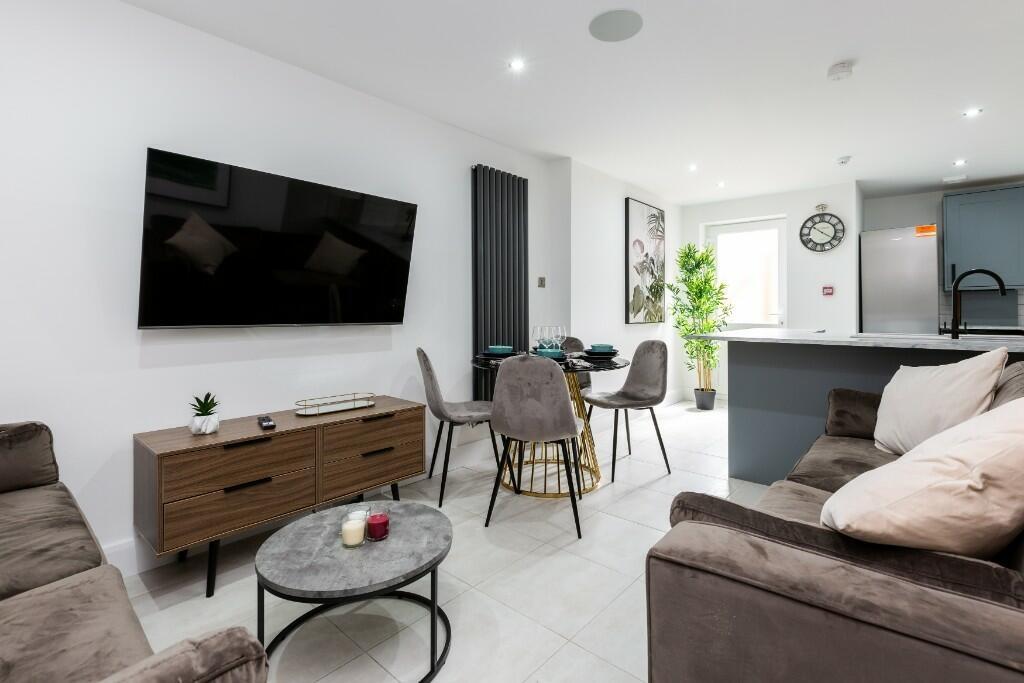 A modern, spacious living room with comfortable...