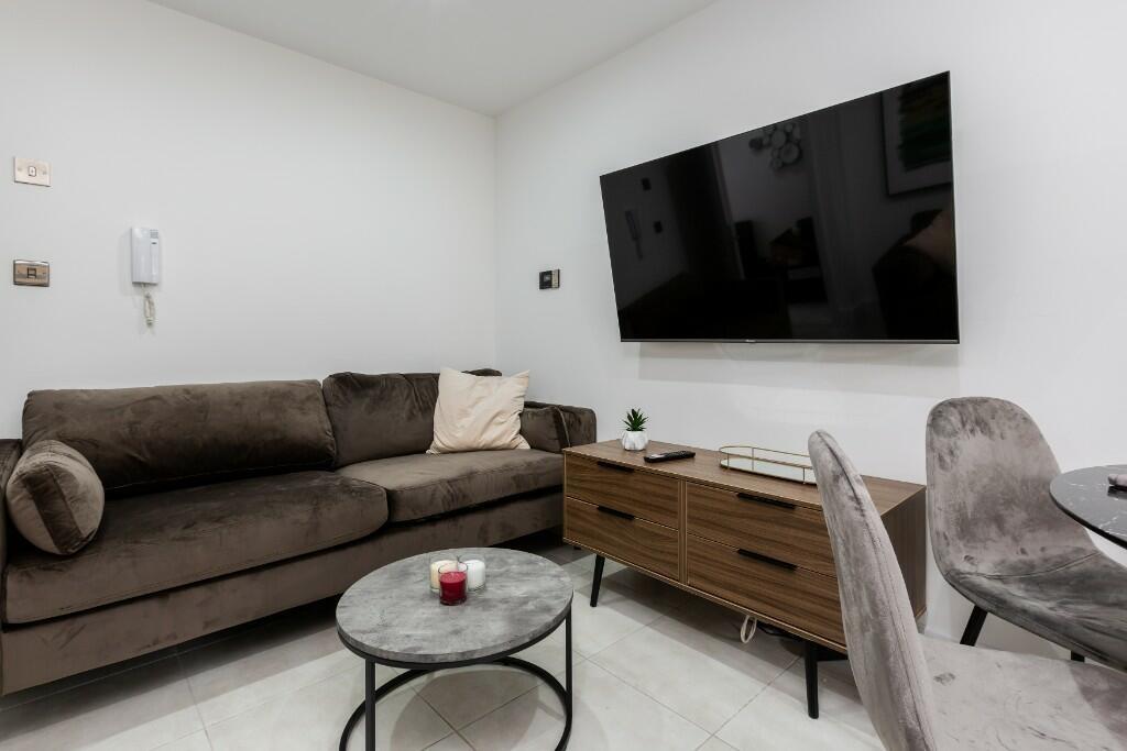 A modern and spacious living room featuring a l...