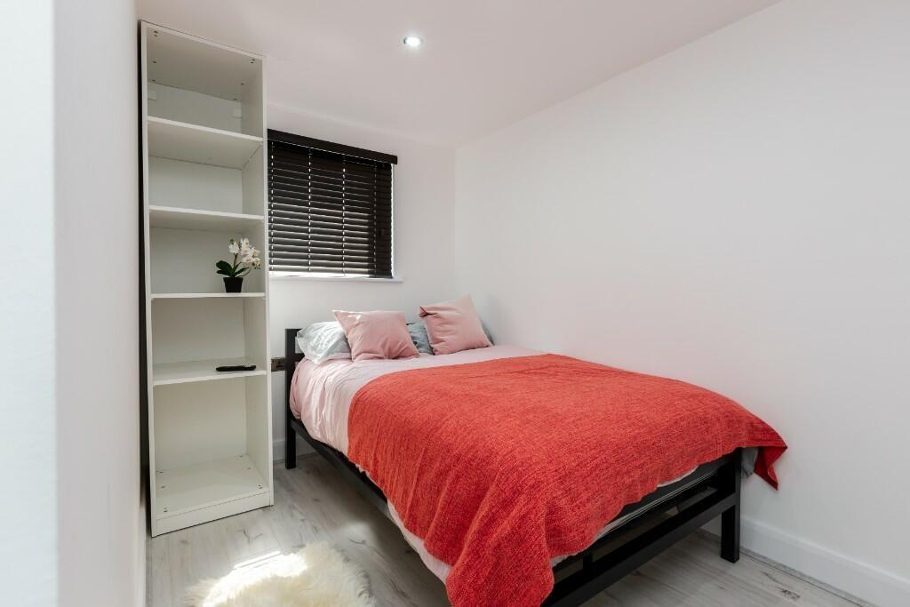 A cozy and well-maintained bedroom featuring a ...