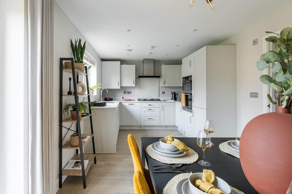An open-plan kitchen and dining area makes the...