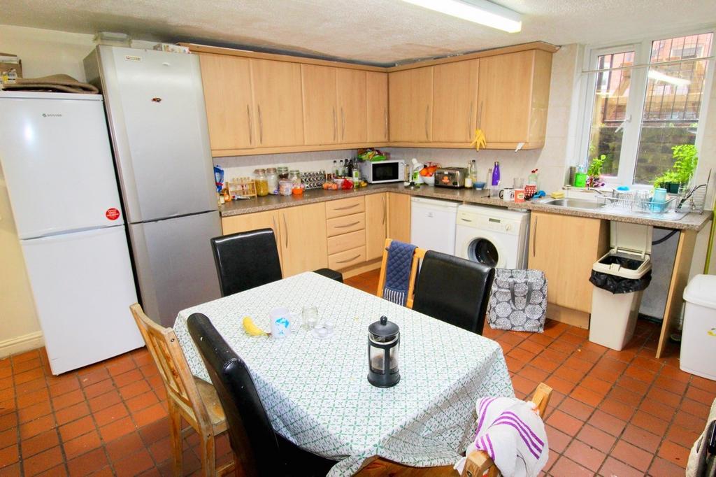 A bright and welcoming kitchen area featuring w...