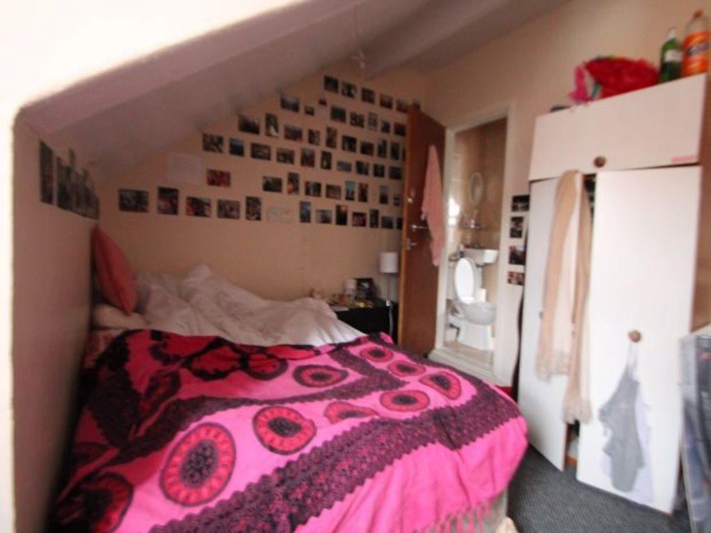A cozy bedroom featuring a double bed with a co...