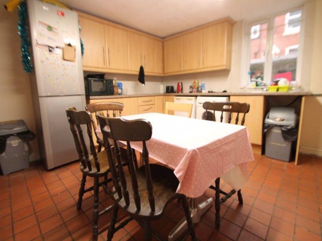 A cozy kitchen area with wooden cabinets, a sma...